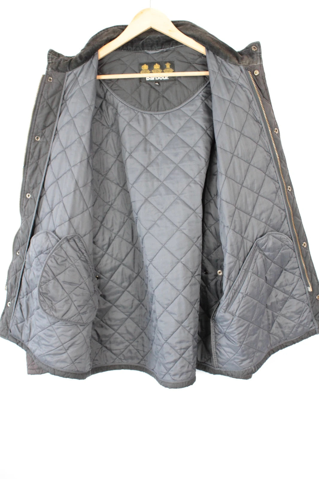 Barbour brown quilted Chelsea jacket with diamond pattern and snap-button storm flap closure.