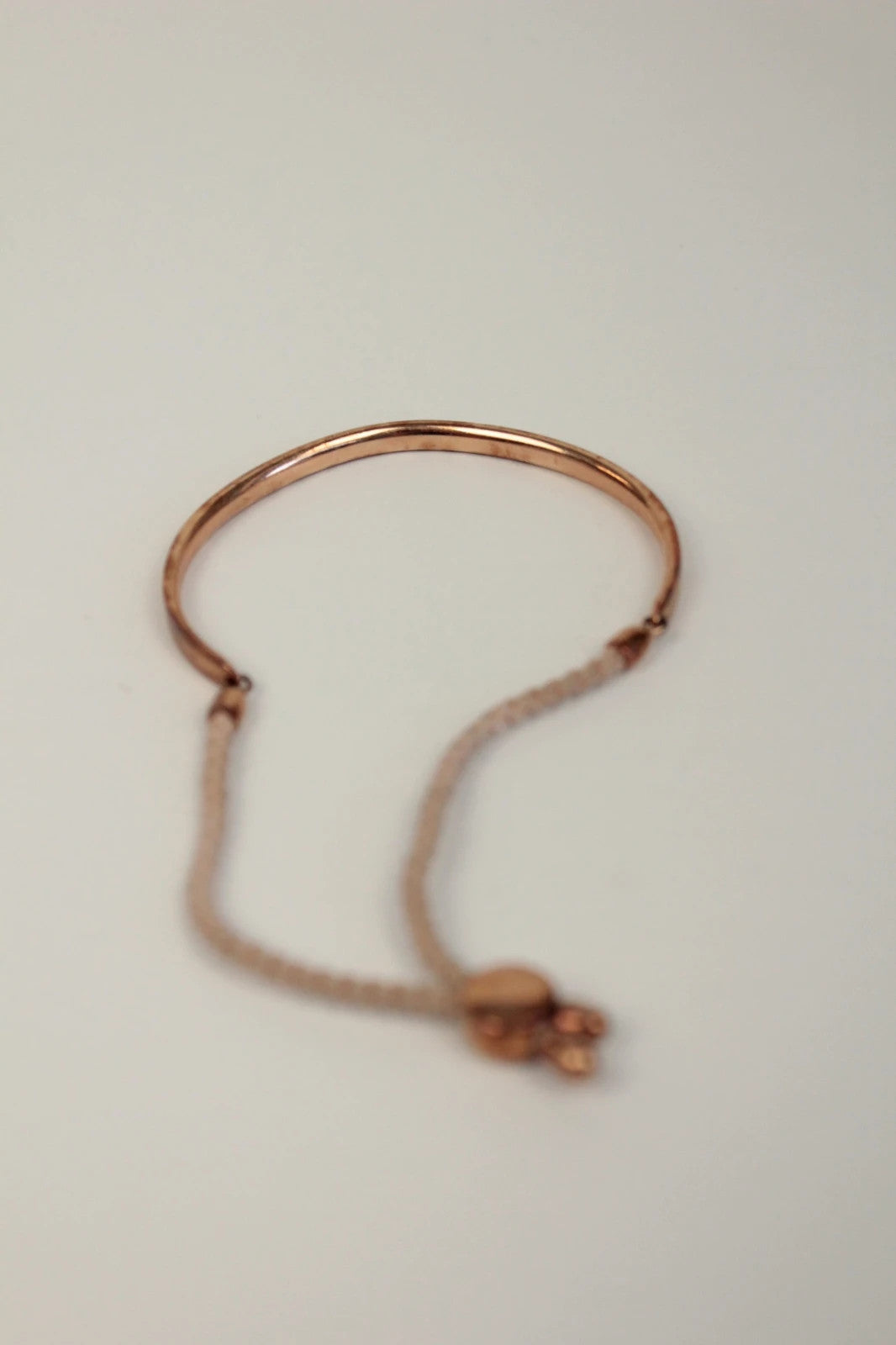 Joy stackable bracelet set rose gold tone with red and pink textile cords.