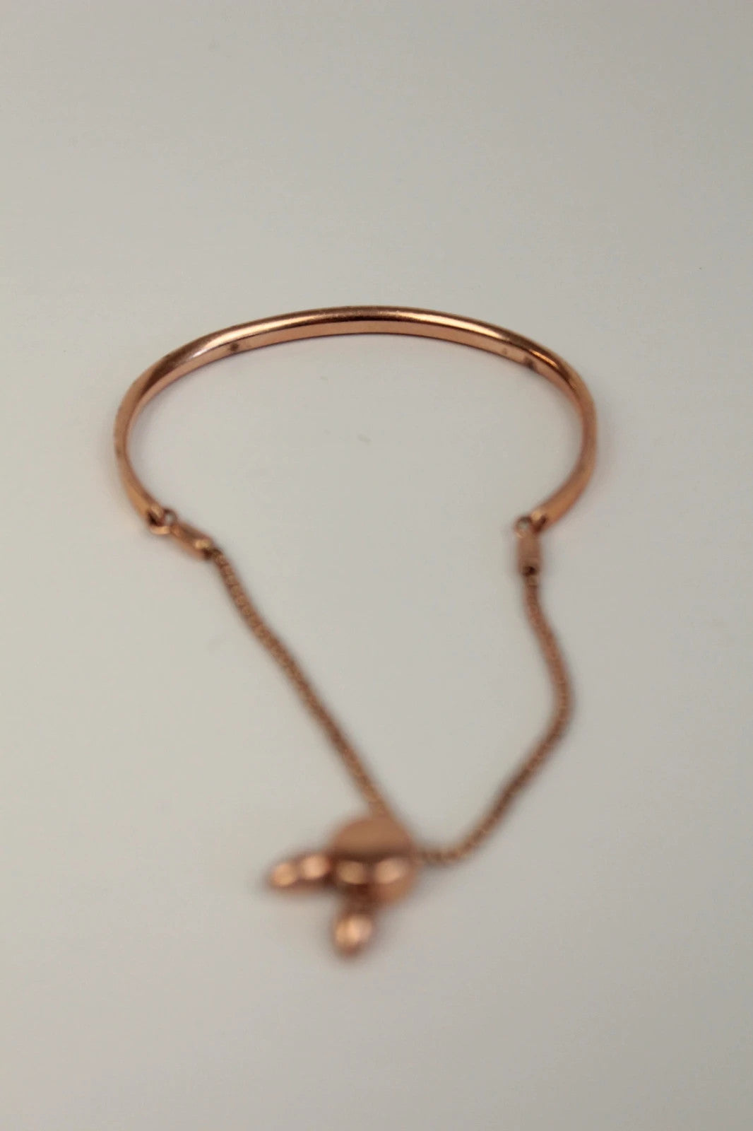 Joy stackable bracelet set rose gold tone with red and pink textile cords.