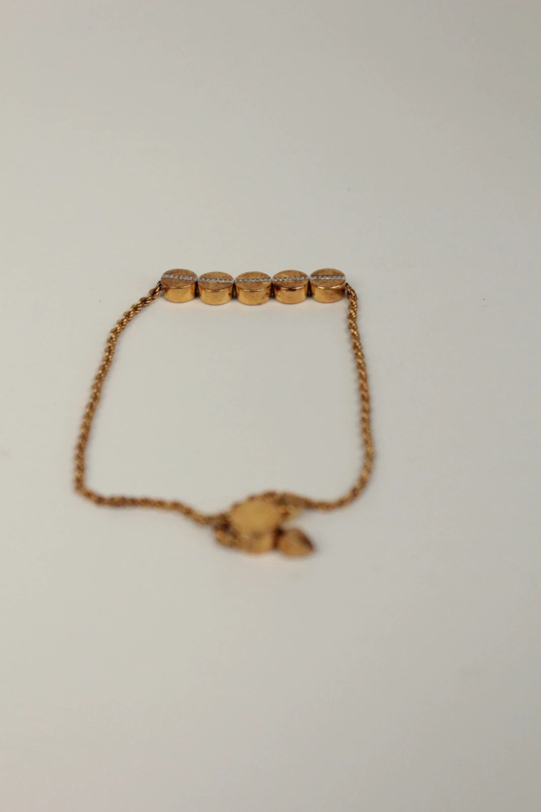Joy stackable bracelet set rose gold tone with red and pink textile cords.