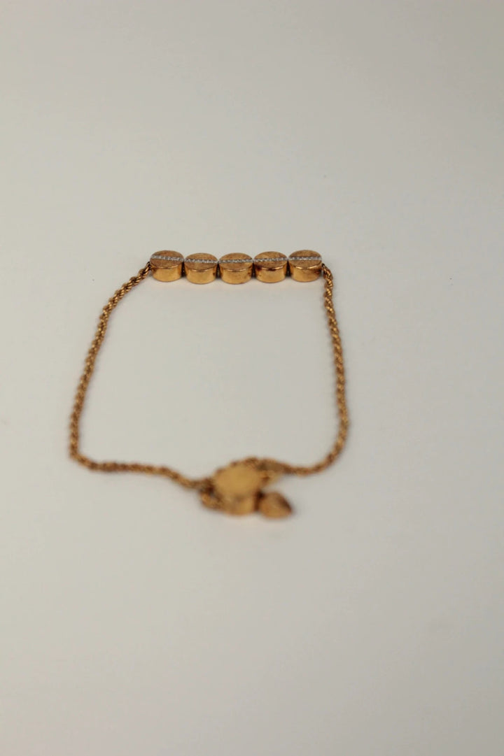 Joy stackable bracelet set rose gold tone with red and pink textile cords.