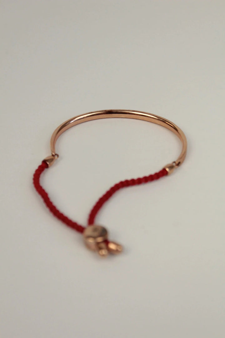 Joy stackable bracelet set rose gold tone with red and pink textile cords.