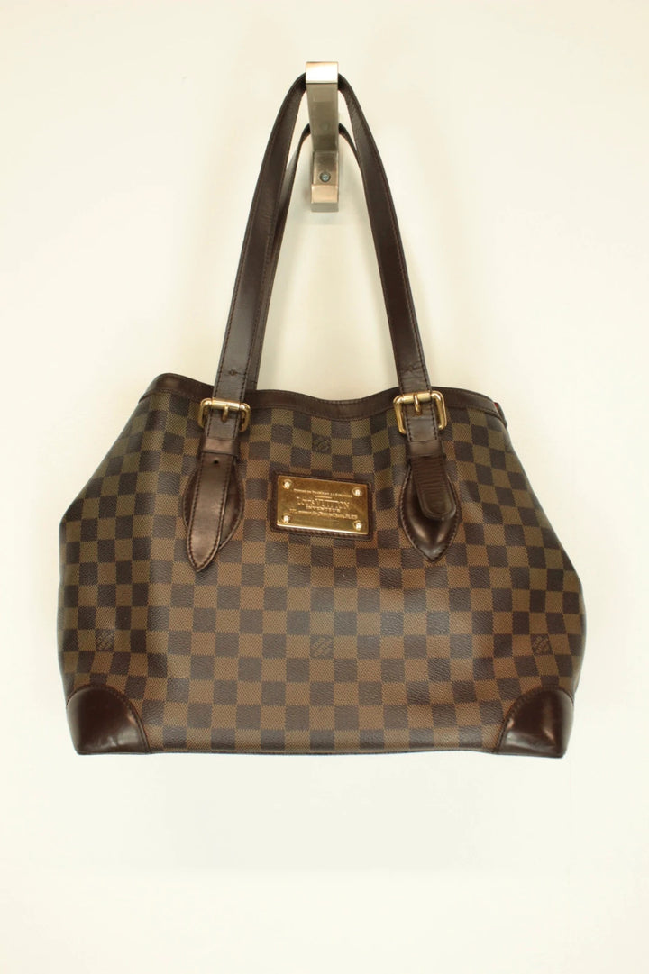 Louis Vuitton brown Hampstead tote bag with Damier Ebene pattern and leather handles.