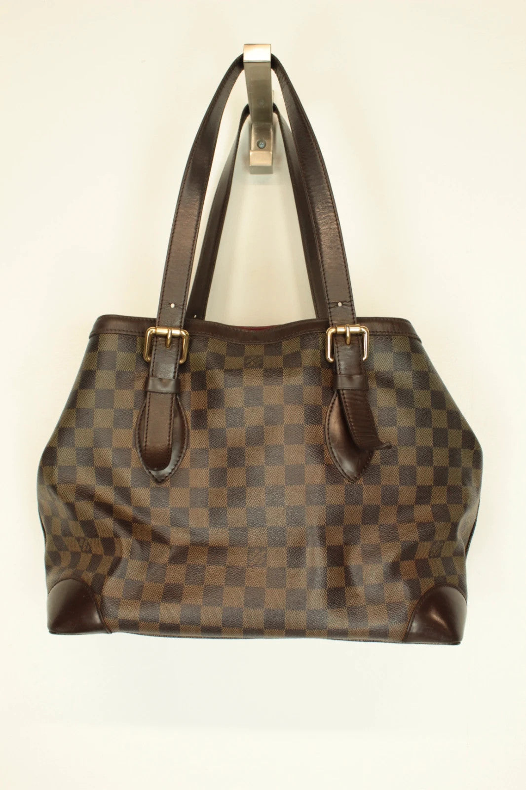 Louis Vuitton brown Hampstead tote bag with Damier Ebene pattern and leather handles.