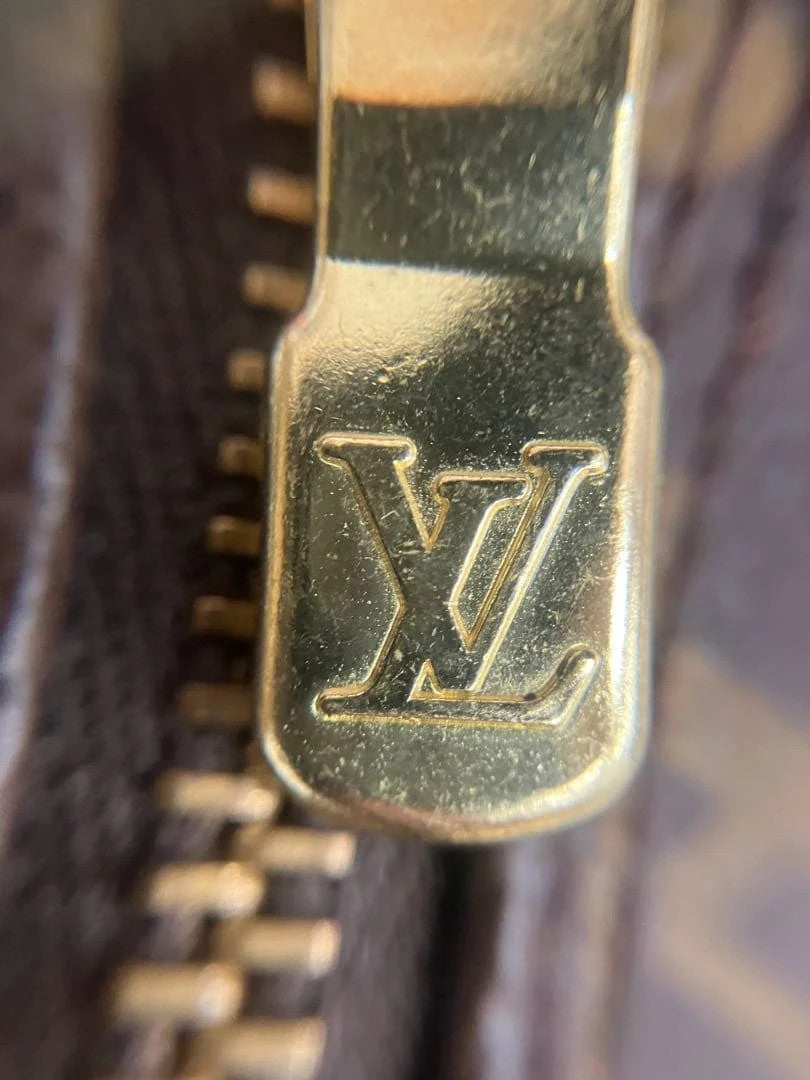 Louis Vuitton brown handbag with monogram pattern, coated canvas, and gold-tone hardware.