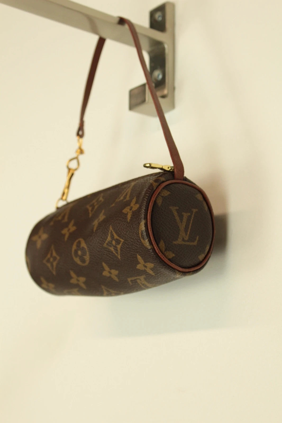 Louis Vuitton brown handbag with monogram pattern, coated canvas, and gold-tone hardware.