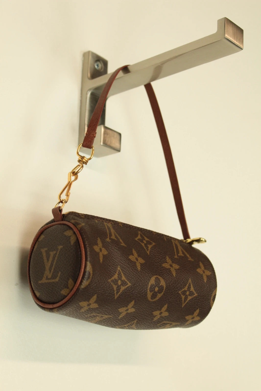 Louis Vuitton brown handbag with monogram pattern, coated canvas, and gold-tone hardware.
