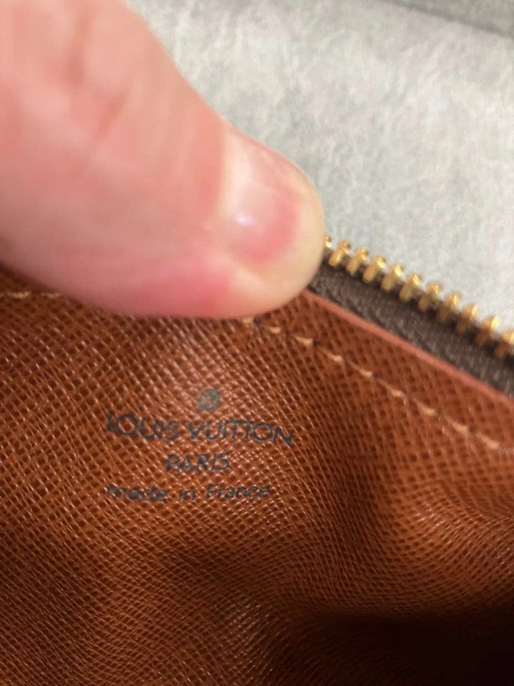 Louis Vuitton brown handbag with monogram pattern, coated canvas, and gold-tone hardware.