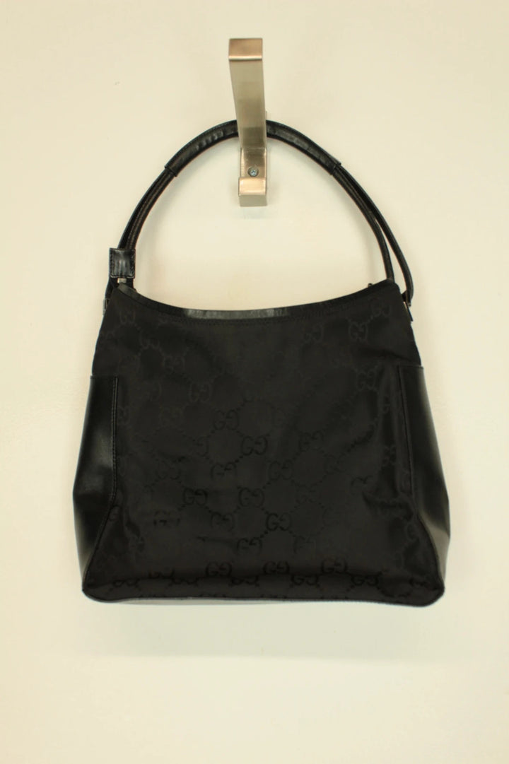 Gucci black hobo shoulder bag with GG monogram pattern and leather trim.