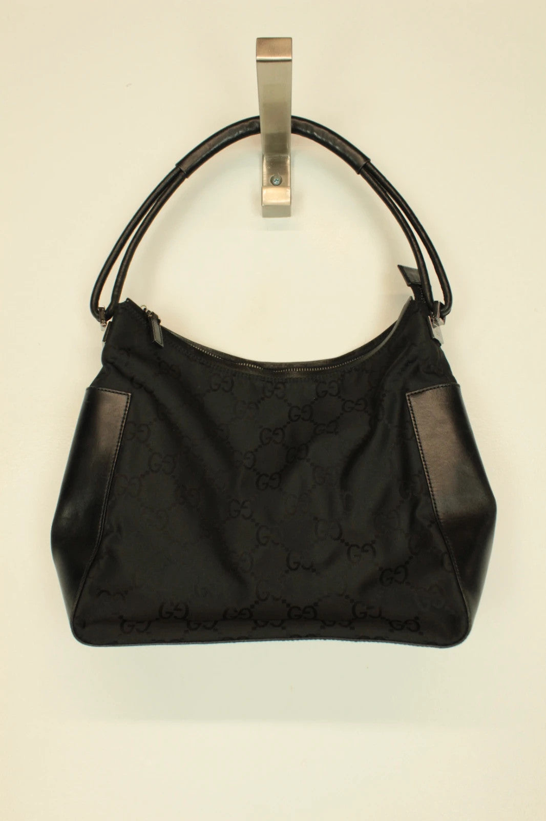 Gucci black hobo shoulder bag with GG monogram pattern and leather trim.