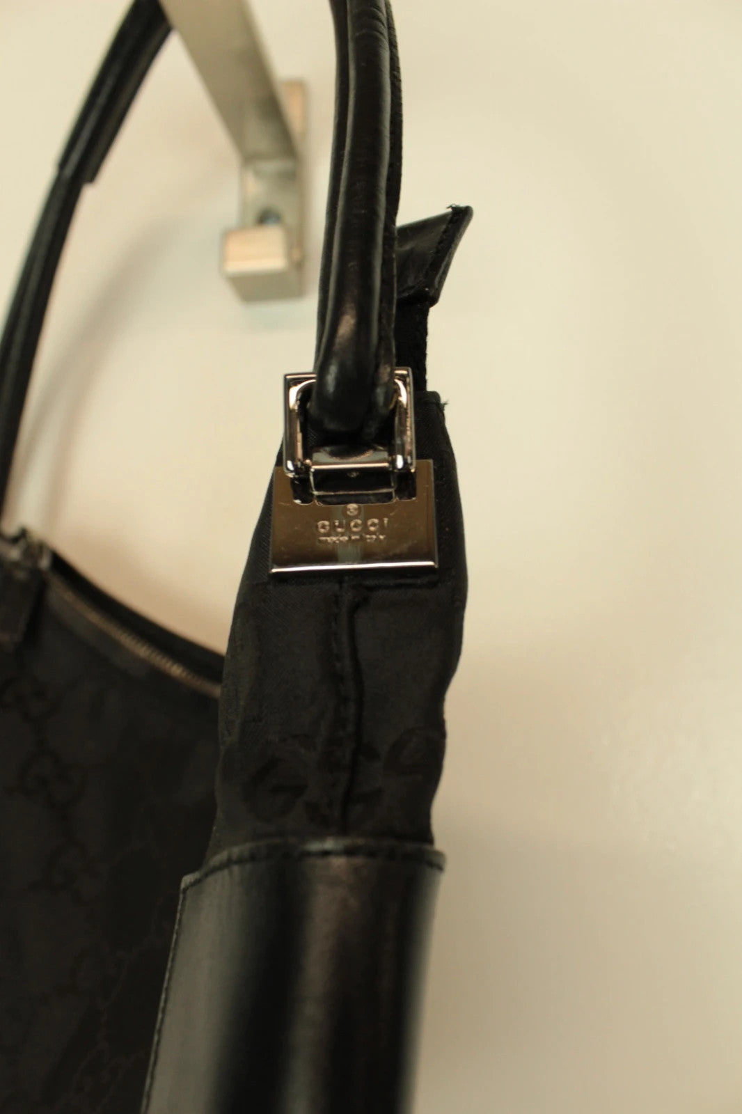 Gucci black hobo shoulder bag with GG monogram pattern and leather trim.