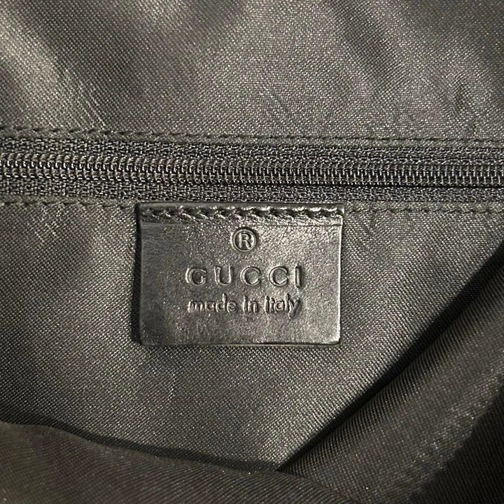 Gucci black hobo shoulder bag with GG monogram pattern and leather trim.