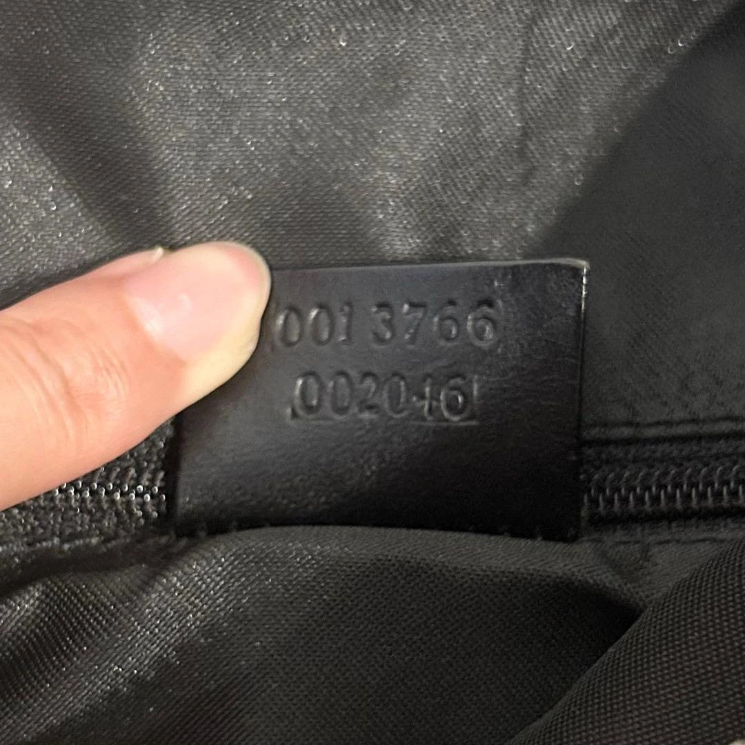Gucci black hobo shoulder bag with GG monogram pattern and leather trim.