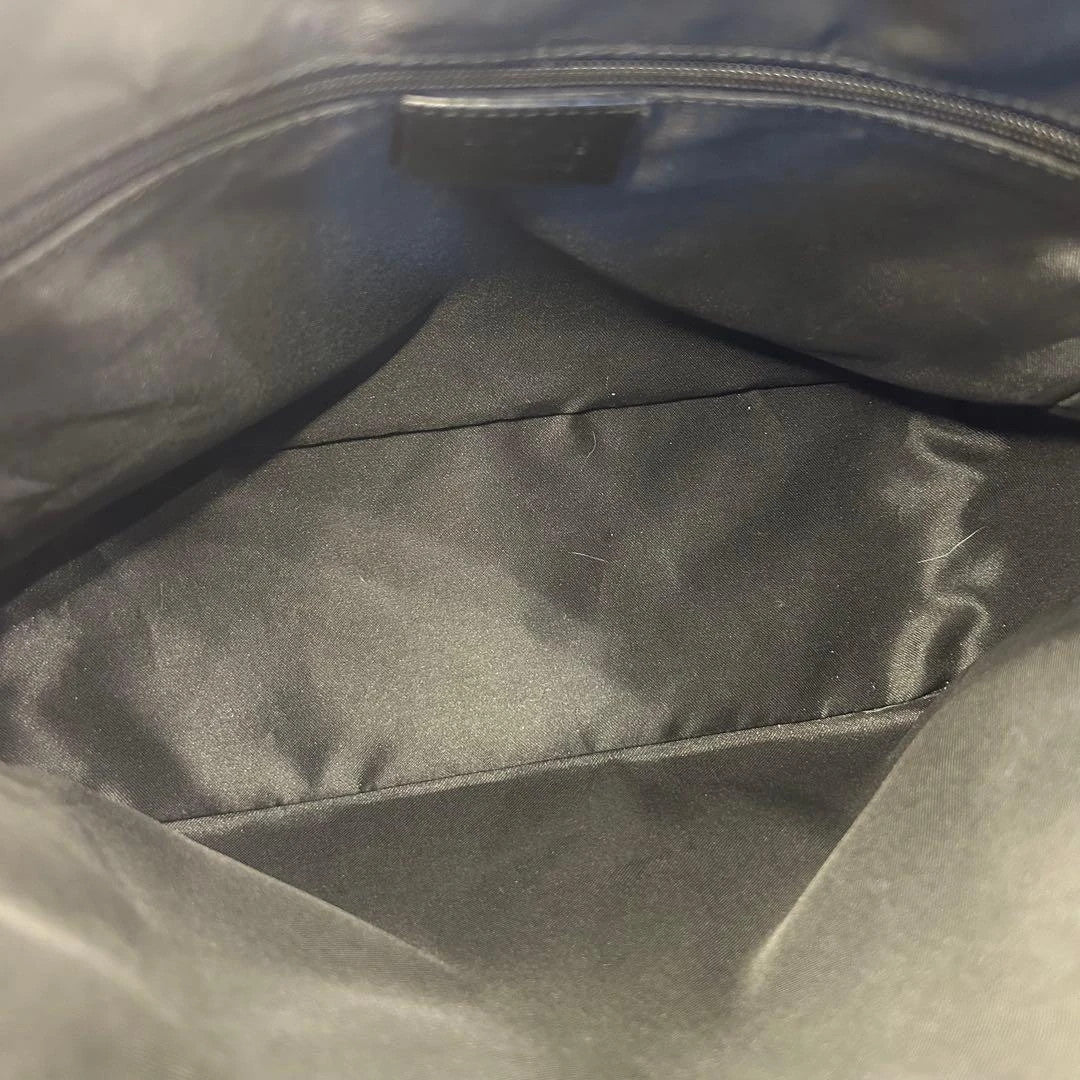 Gucci black hobo shoulder bag with GG monogram pattern and leather trim.