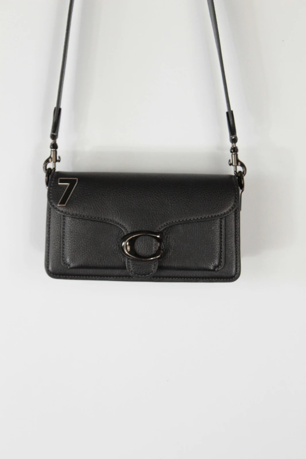 Coach black Tabby 20 clutch bag in polished pebble leather with pewter C logo hardware.