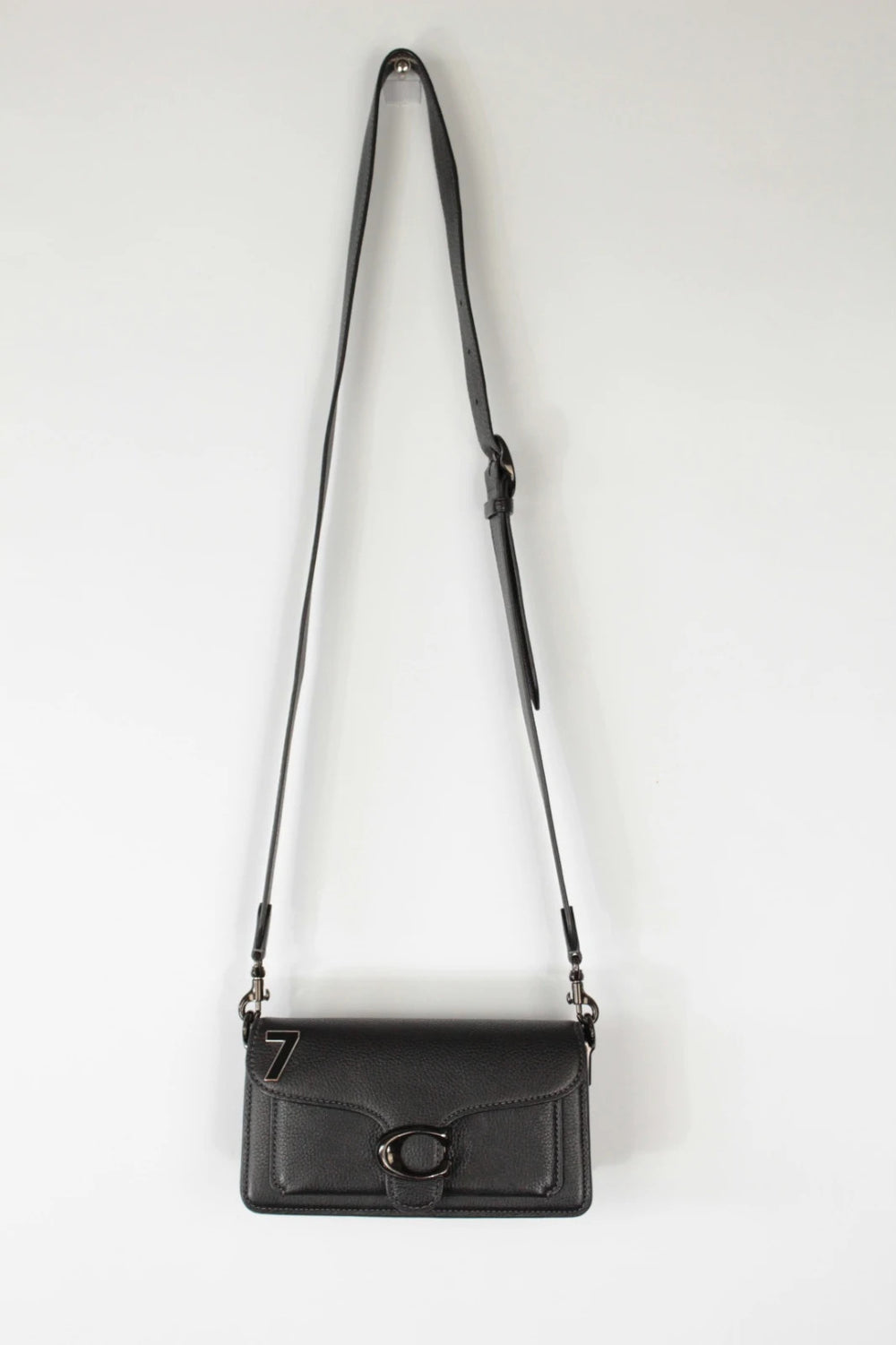 Coach black Tabby 20 clutch bag in polished pebble leather with pewter C logo hardware.