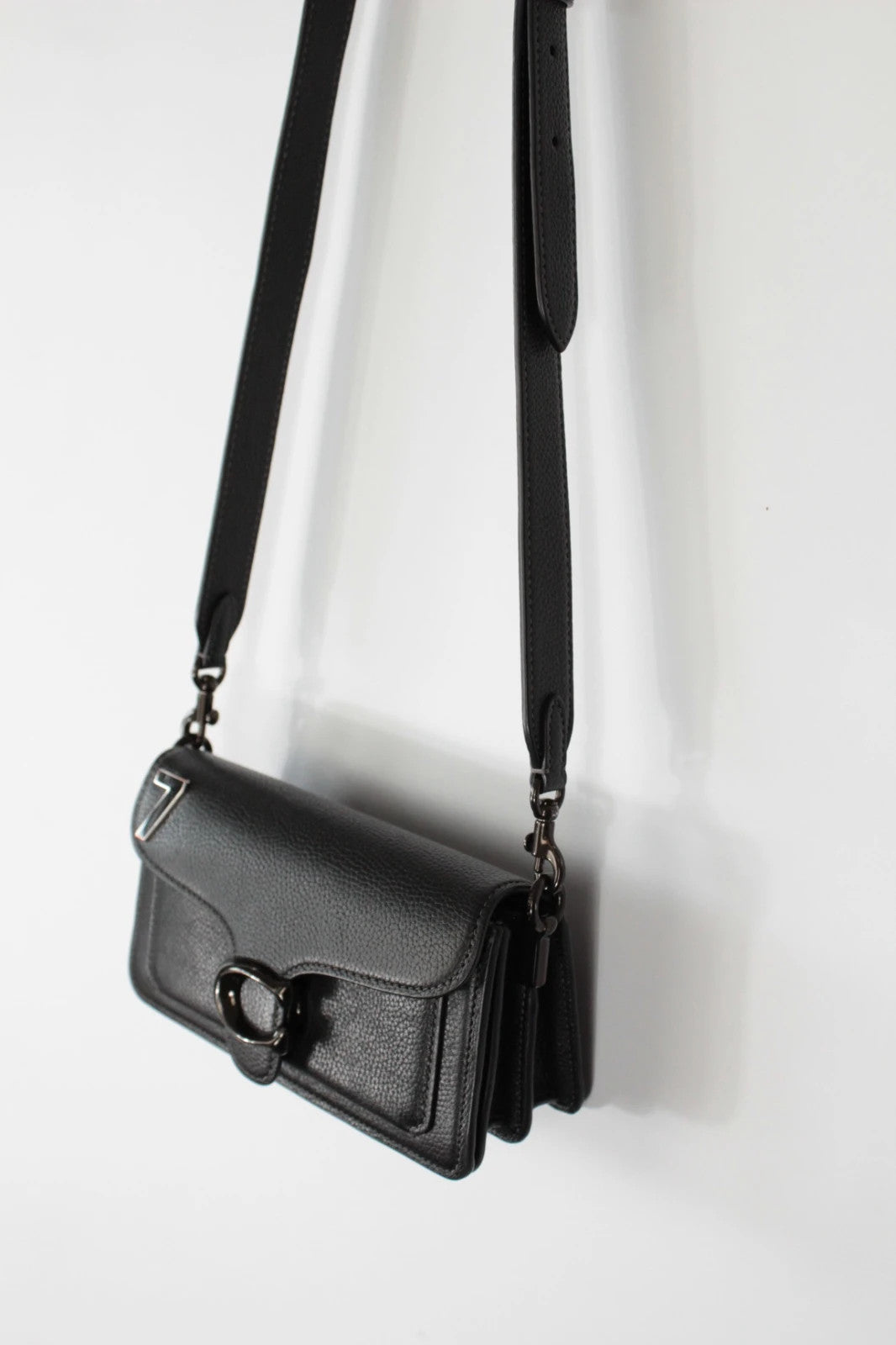 Coach black Tabby 20 clutch bag in polished pebble leather with pewter C logo hardware.