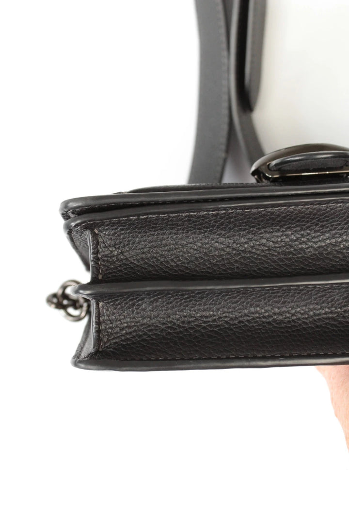 Coach black Tabby 20 clutch bag in polished pebble leather with pewter C logo hardware.