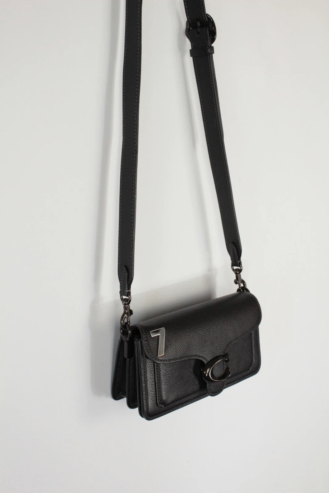 Coach black Tabby 20 clutch bag in polished pebble leather with pewter C logo hardware.