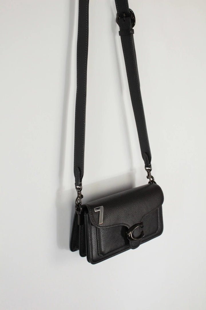 Coach black Tabby 20 clutch bag in polished pebble leather with pewter C logo hardware.