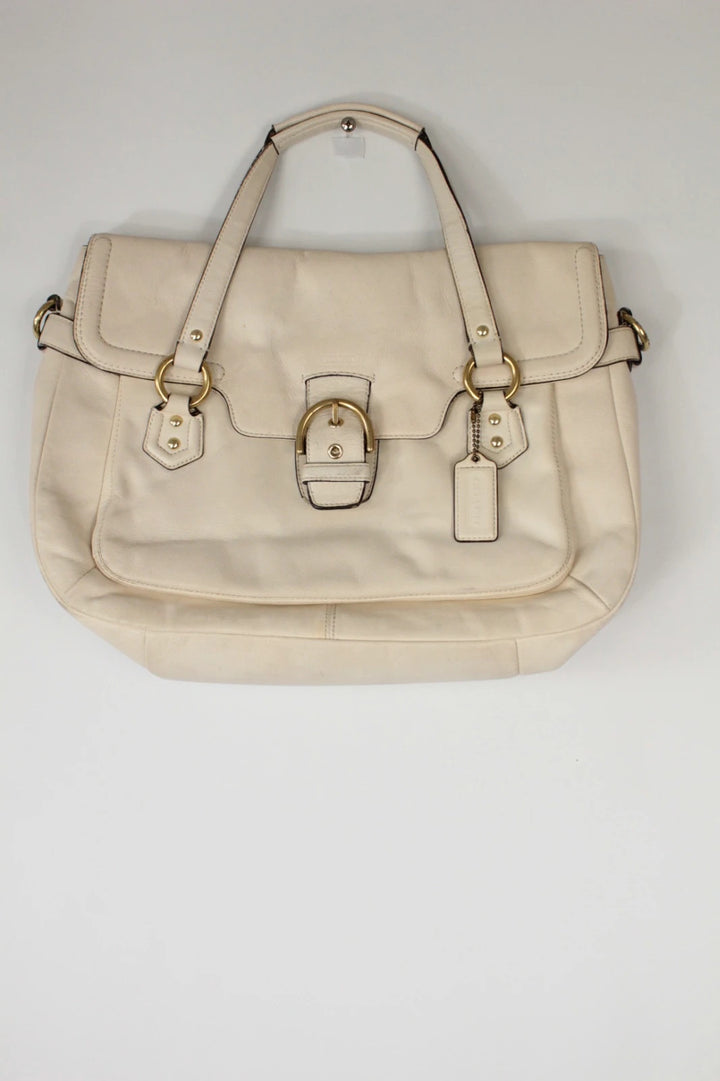 Coach cream leather satchel bag with gold-tone buckle clasp and matching hangtag.