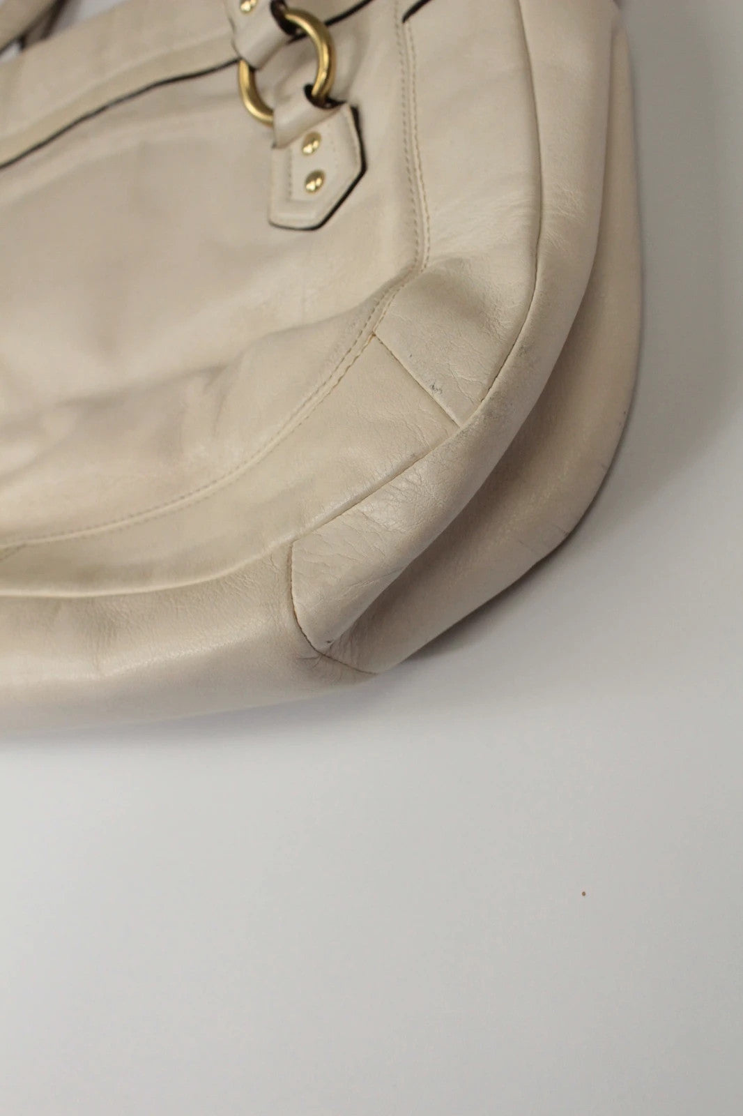 Coach cream leather satchel bag with gold-tone buckle clasp and matching hangtag.