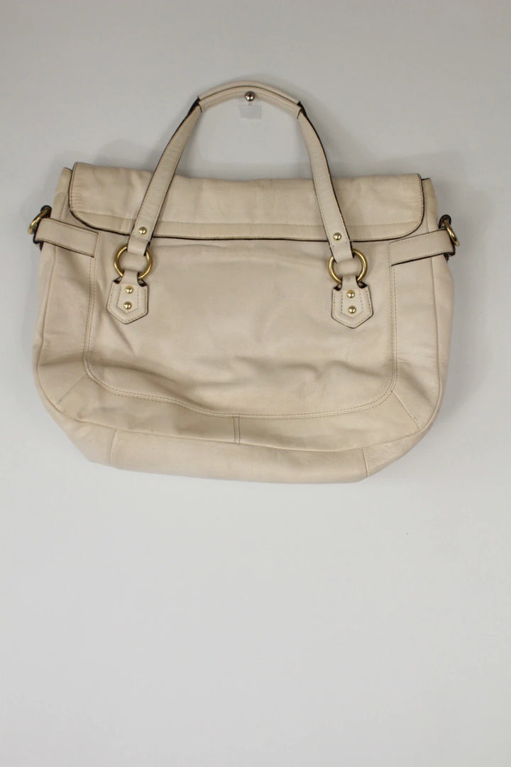 Coach cream leather satchel bag with gold-tone buckle clasp and matching hangtag.