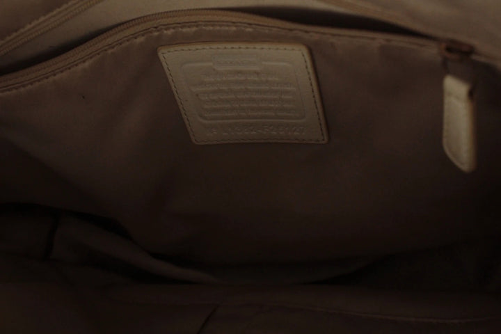 Coach cream leather satchel bag with gold-tone buckle clasp and matching hangtag.