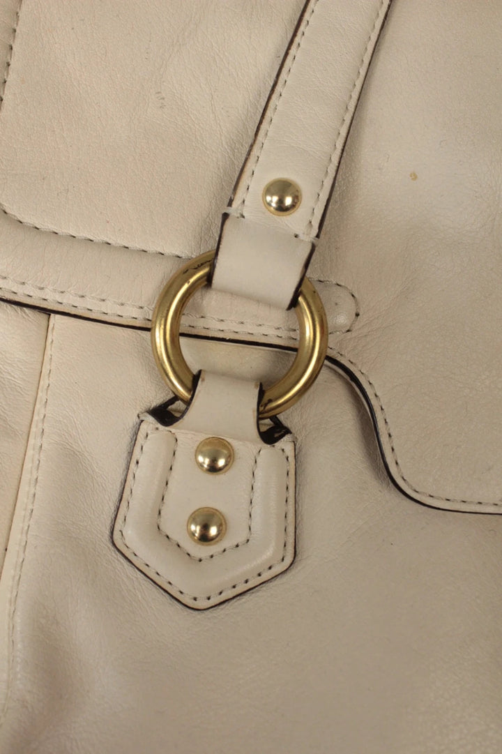 Coach cream leather satchel bag with gold-tone buckle clasp and matching hangtag.