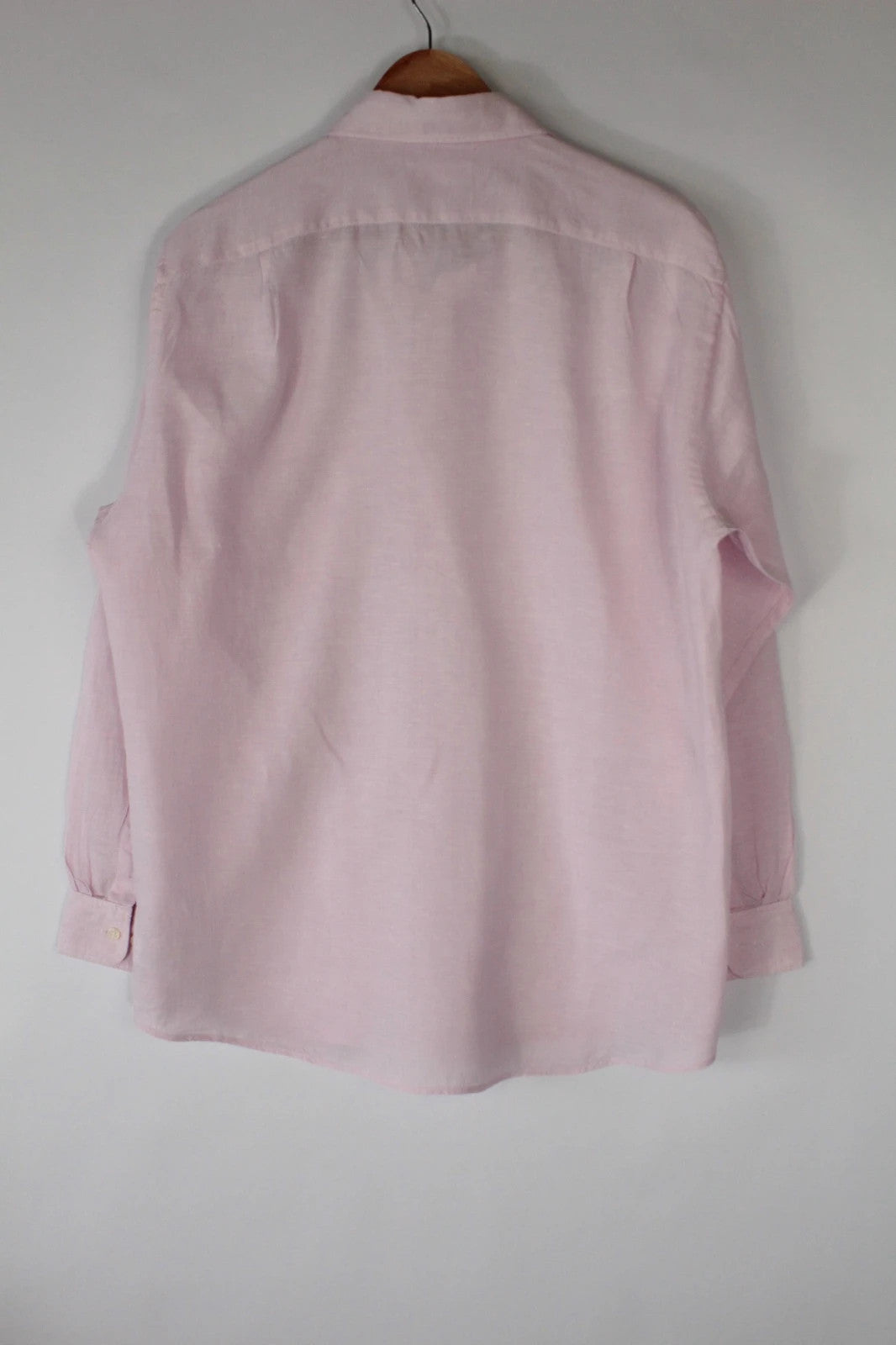 Uniqlo light pink long sleeve linen shirt with classic white buttons and chest pocket.