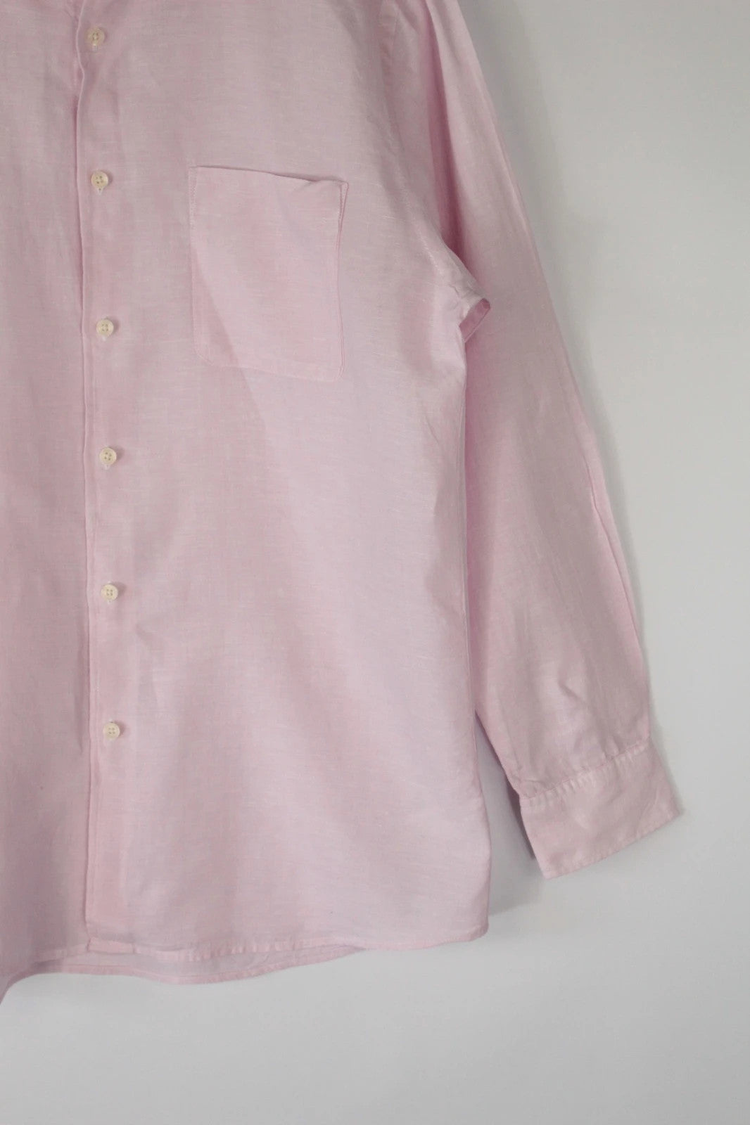 Uniqlo light pink long sleeve linen shirt with classic white buttons and chest pocket.