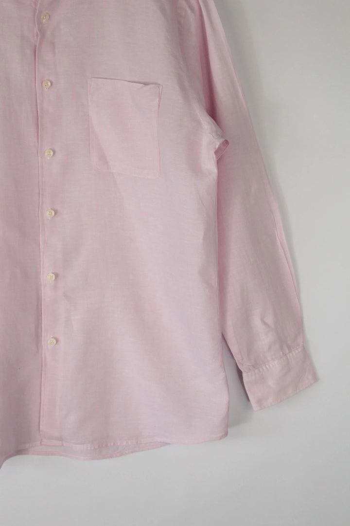 Uniqlo light pink long sleeve linen shirt with classic white buttons and chest pocket.