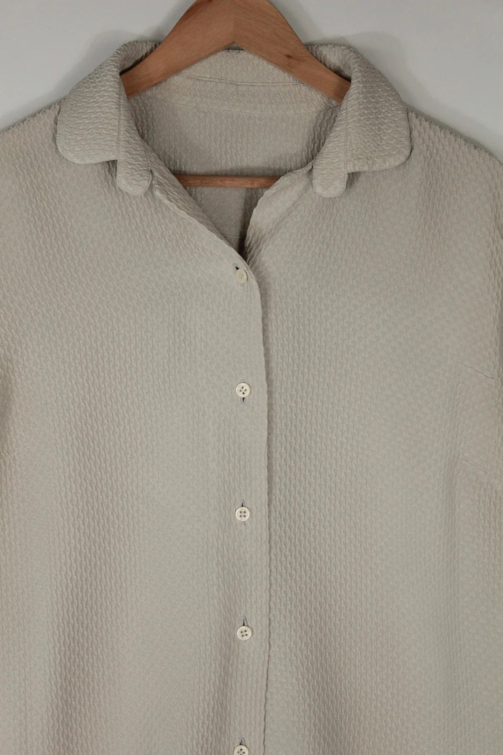 Vintage Dressing beige crinkle blouse with textured waffle fabric and classic button-up front.