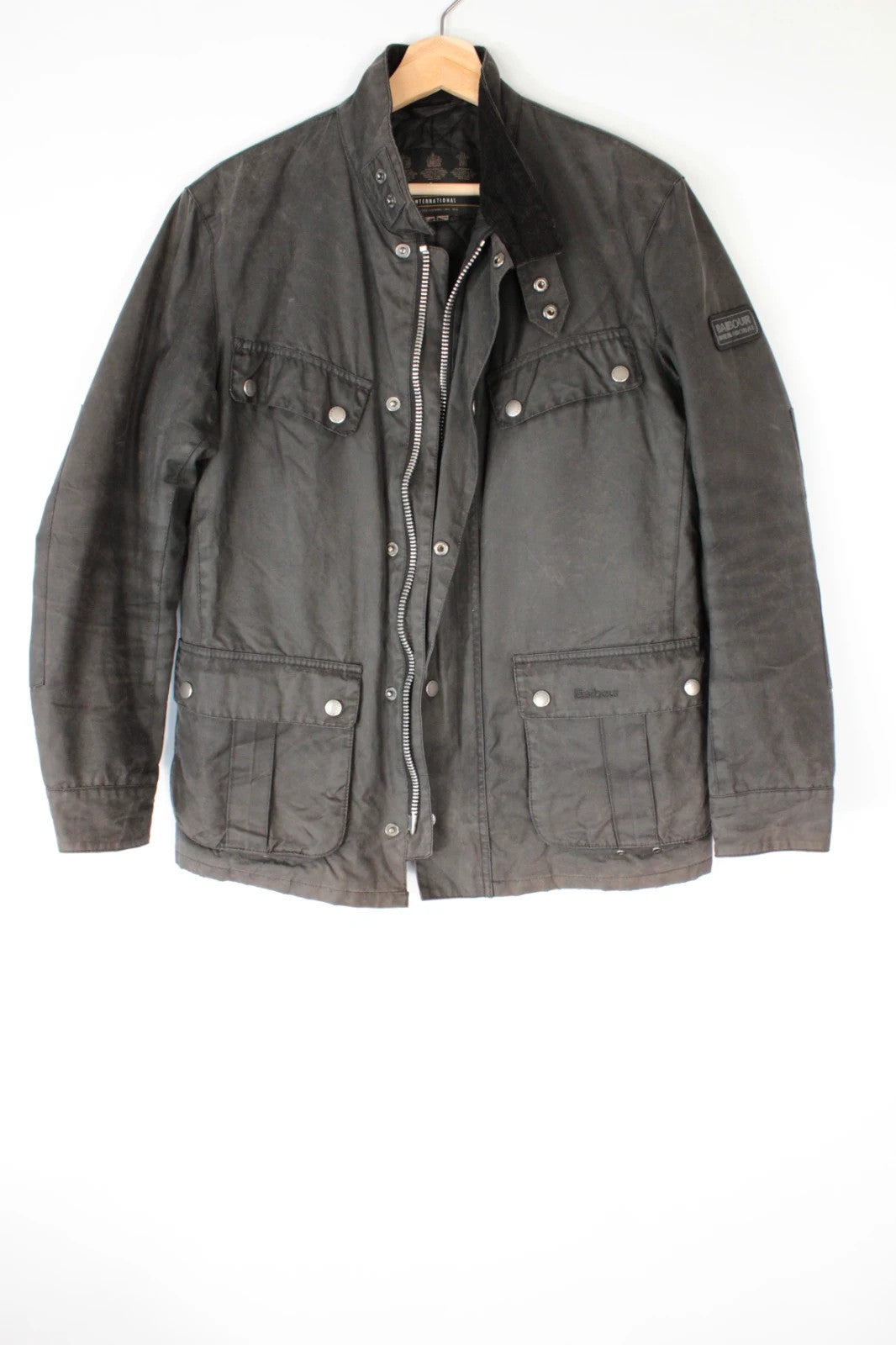 Barbour black waxed cotton motorcycle jacket with corduroy trim and vintage patina.