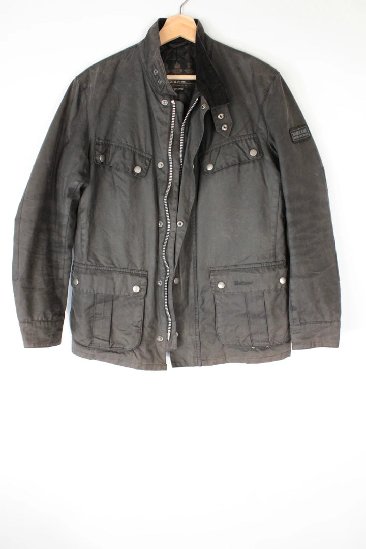 Barbour black waxed cotton motorcycle jacket with corduroy trim and vintage patina.