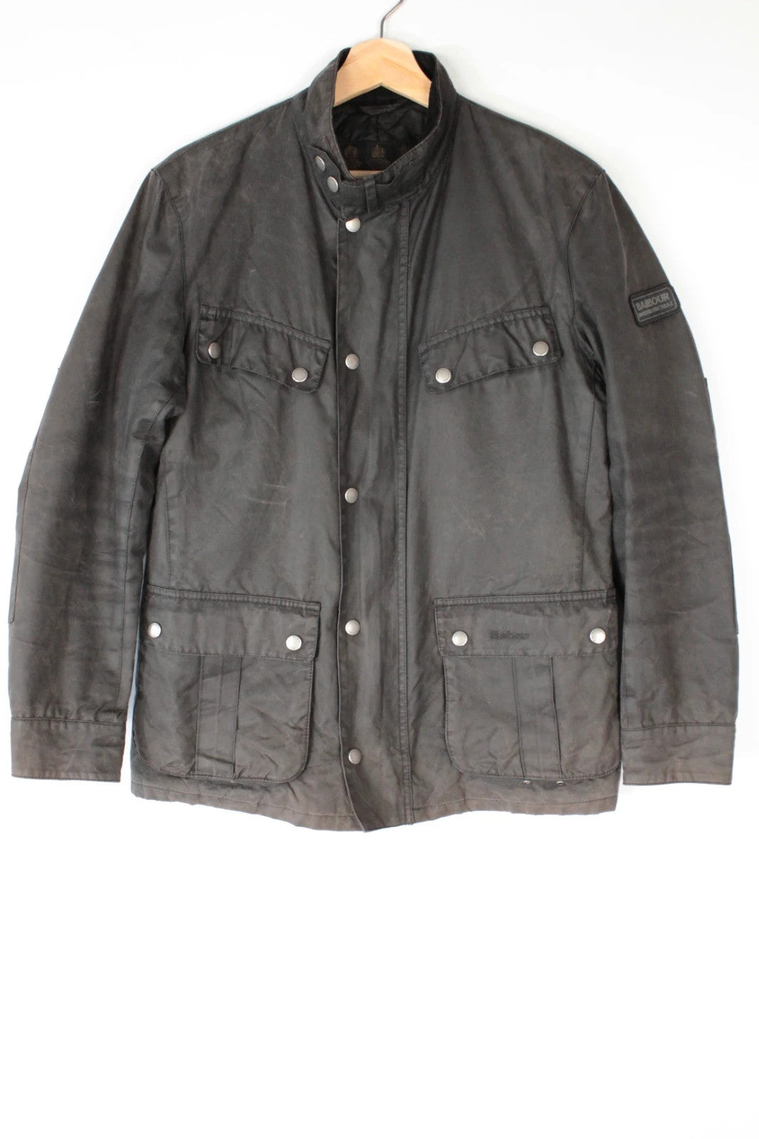 Barbour black waxed cotton motorcycle jacket with corduroy trim and vintage patina.