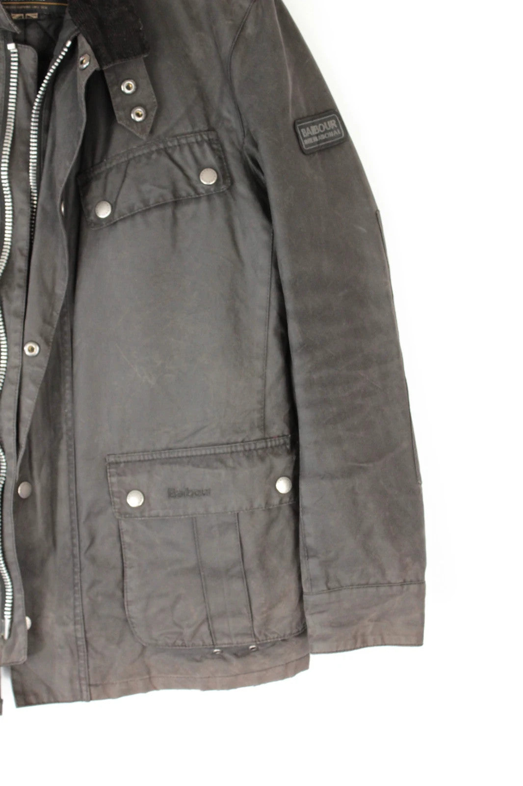 Barbour black waxed cotton motorcycle jacket with corduroy trim and vintage patina.