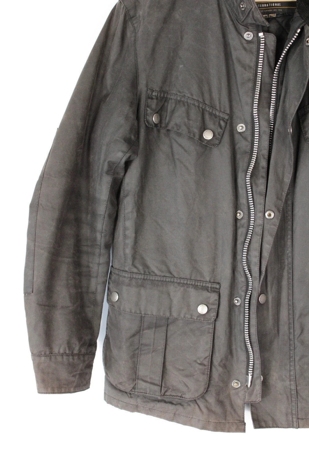 Barbour black waxed cotton motorcycle jacket with corduroy trim and vintage patina.