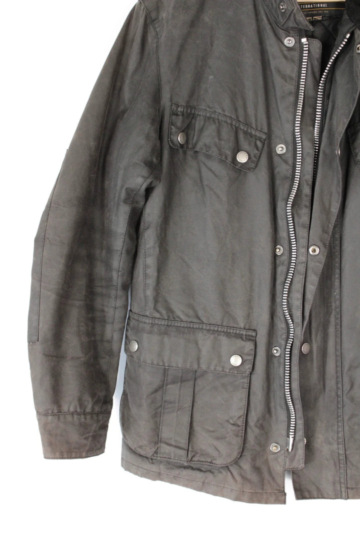 Barbour black waxed cotton motorcycle jacket with corduroy trim and vintage patina.