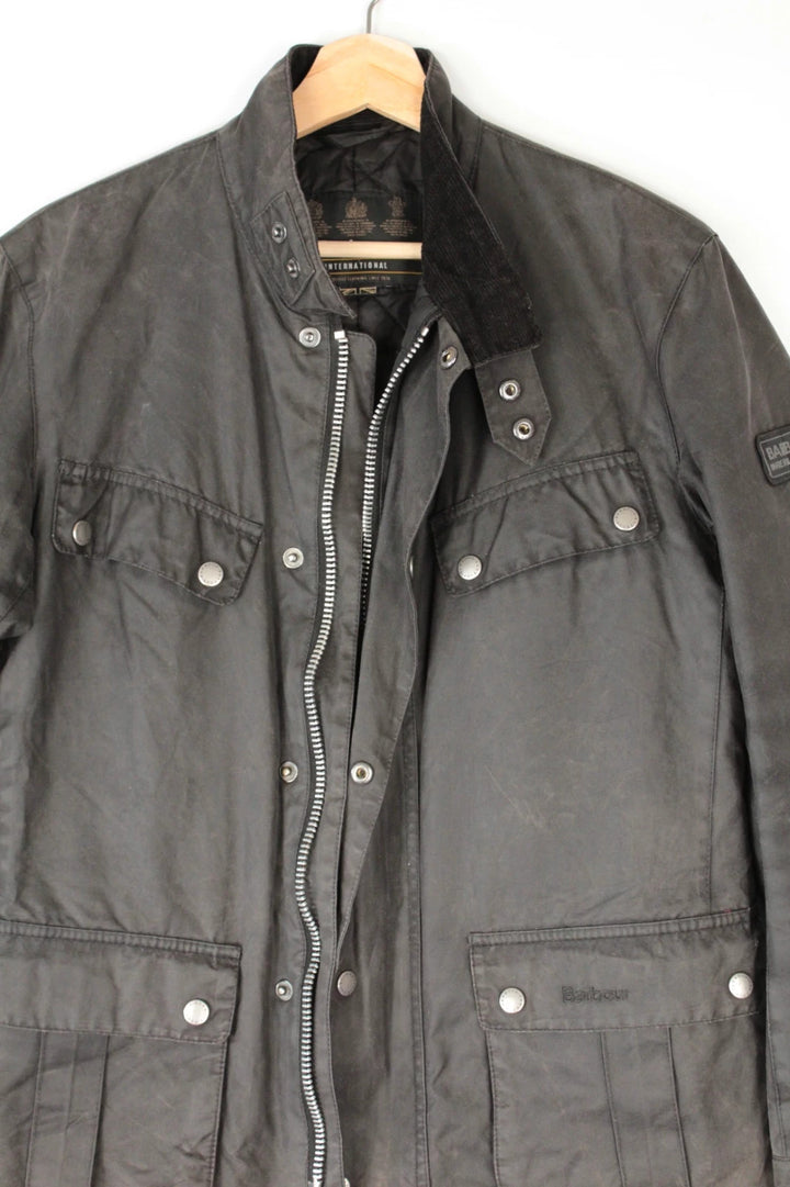 Barbour black waxed cotton motorcycle jacket with corduroy trim and vintage patina.