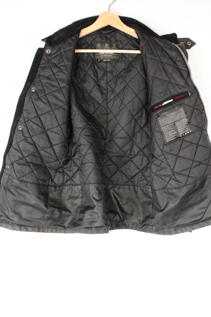 Barbour black waxed cotton motorcycle jacket with corduroy trim and vintage patina.
