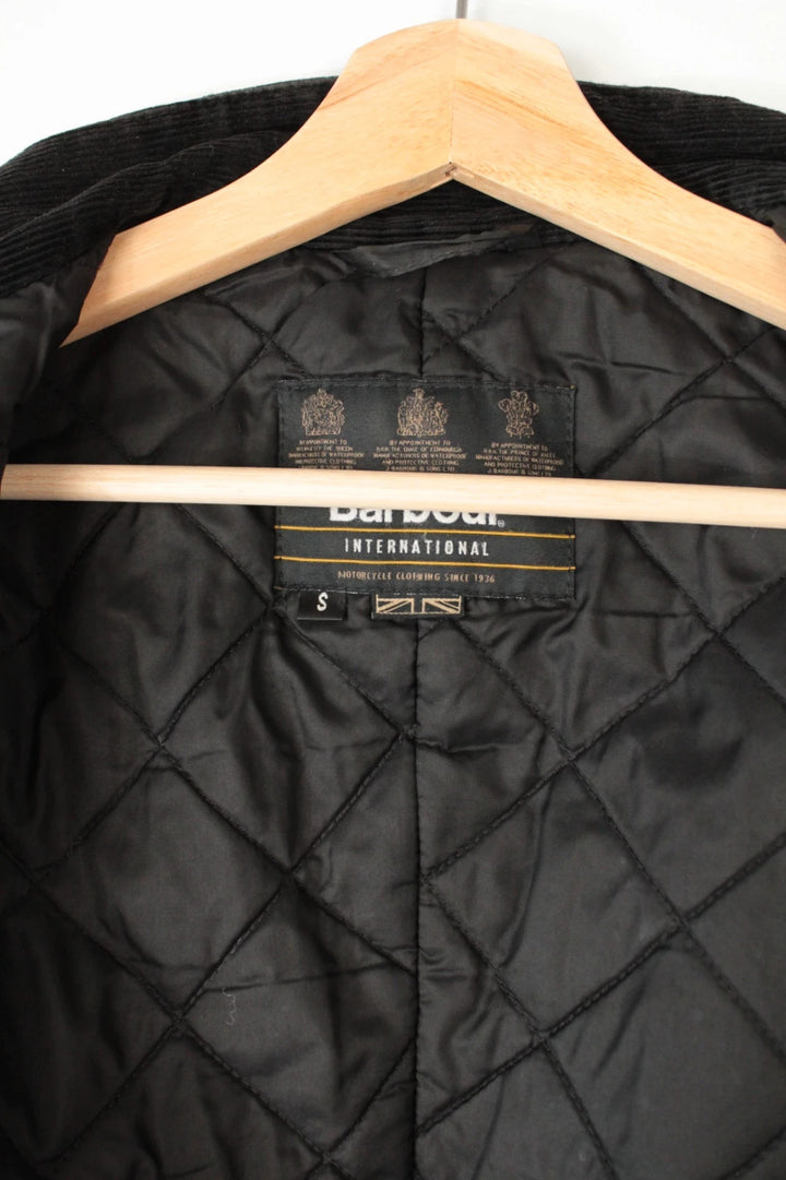 Barbour black waxed cotton motorcycle jacket with corduroy trim and vintage patina.