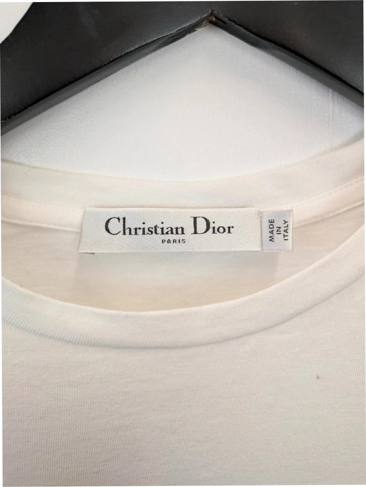 Christian Dior white pocket t-shirt with graphic protest illustration and bee motif.