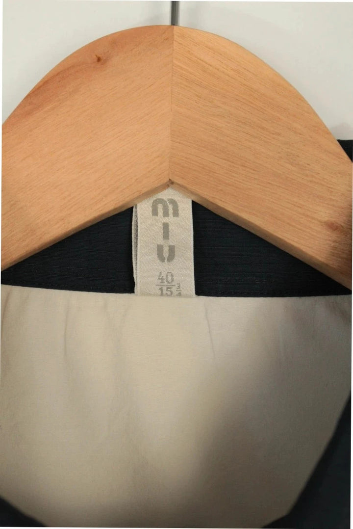 Miu Miu cream and navy collared blouse with contrast trim and premium cotton blend.
