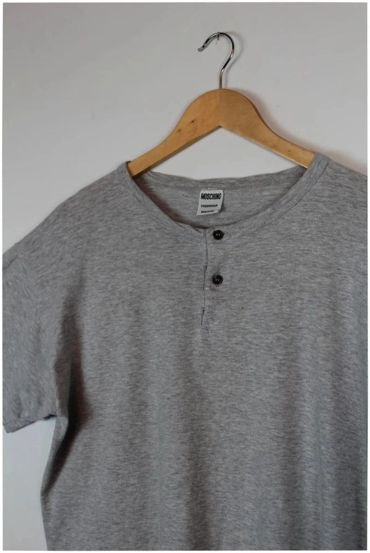 Moschino grey cotton polo shirt with rounded neckline and two front buttons, vintage style.