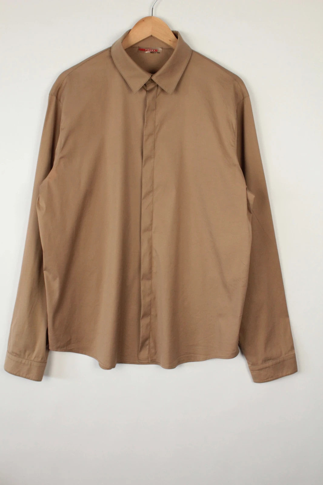 Prada beige stretch cotton shirt with hidden placket and sharp pointed collar.