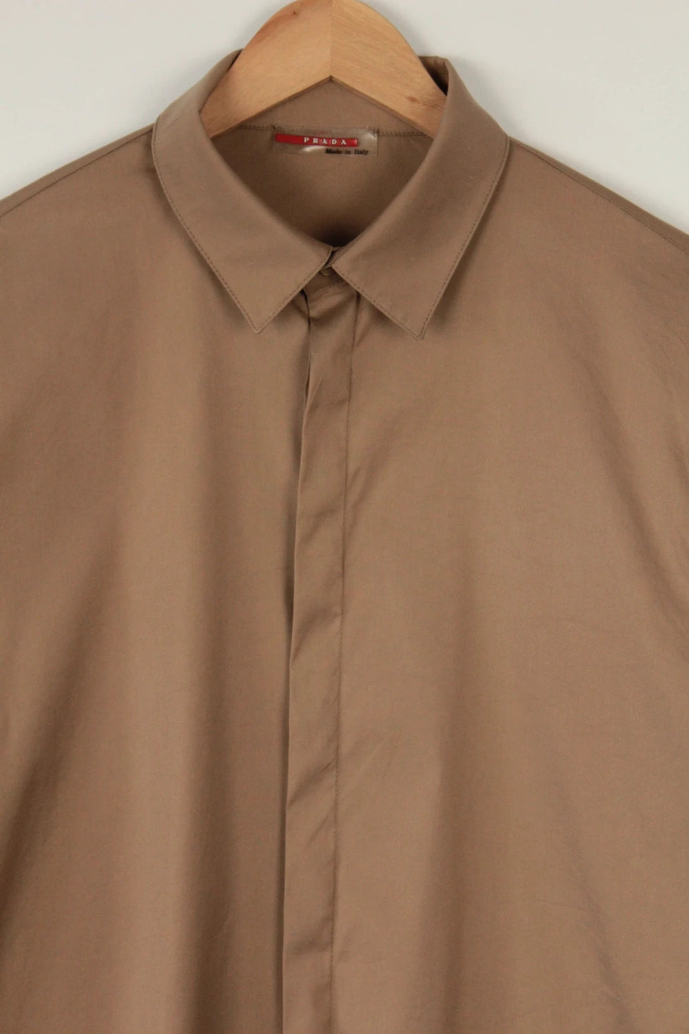 Prada beige stretch cotton shirt with hidden placket and sharp pointed collar.