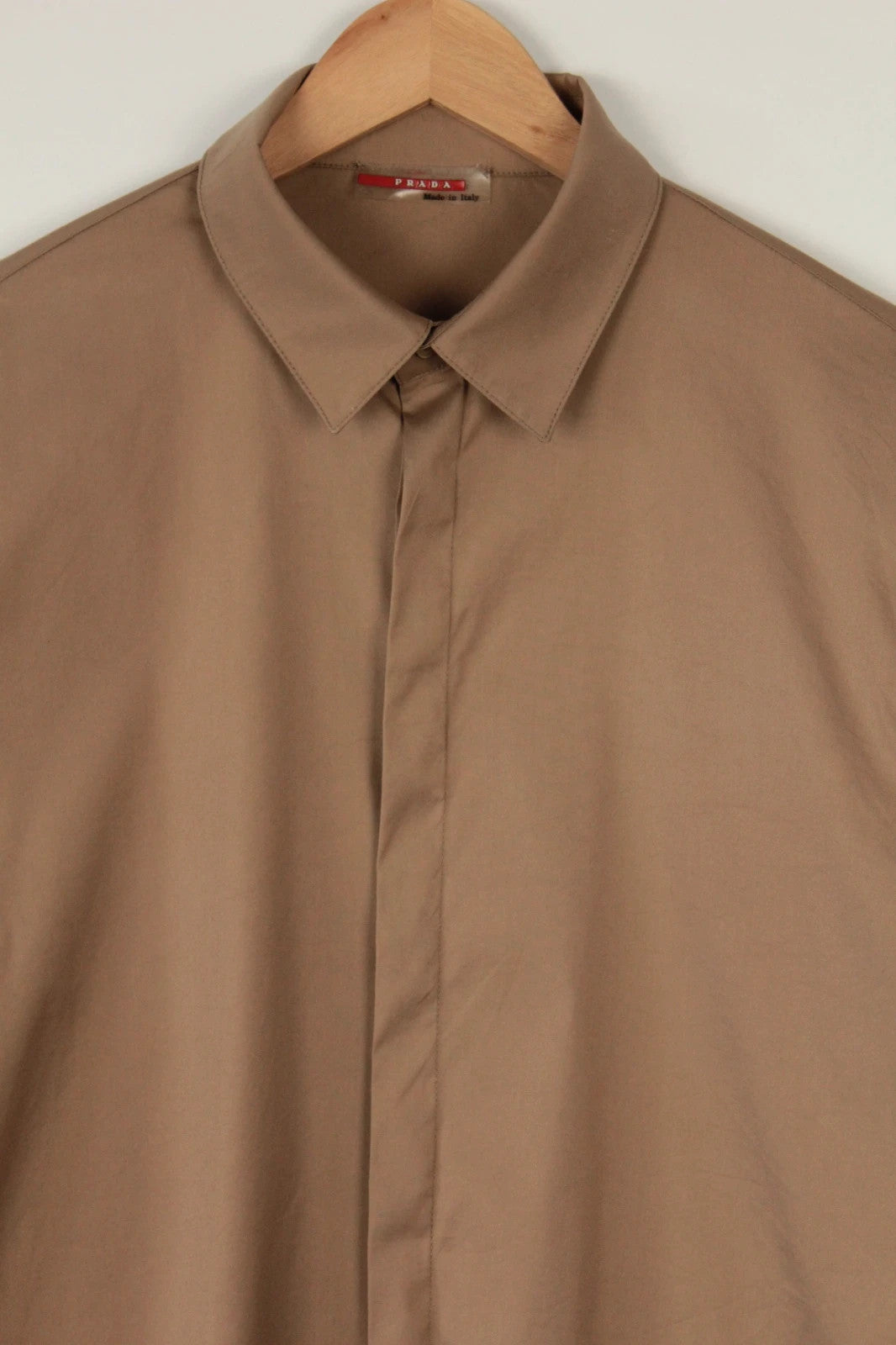 Prada beige stretch cotton shirt with hidden placket and sharp pointed collar.