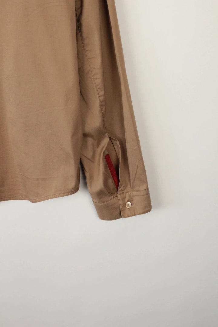 Prada beige stretch cotton shirt with hidden placket and sharp pointed collar.