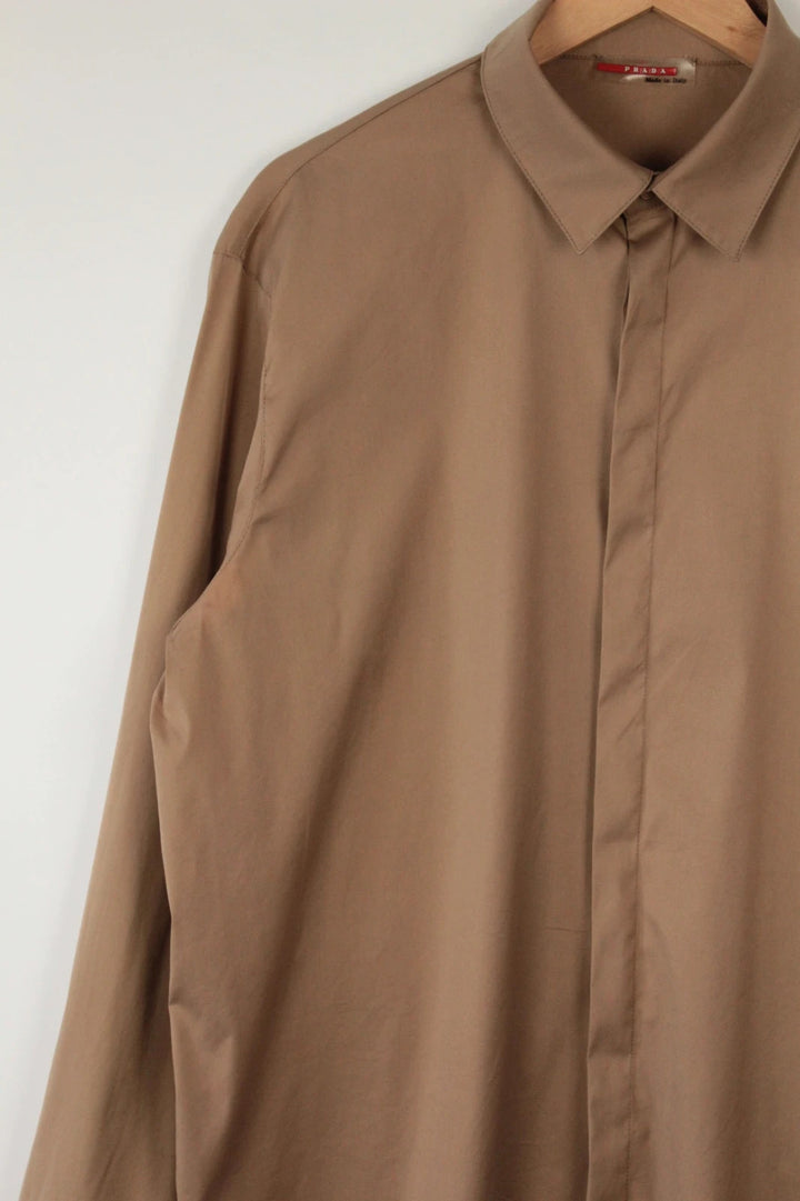 Prada beige stretch cotton shirt with hidden placket and sharp pointed collar.